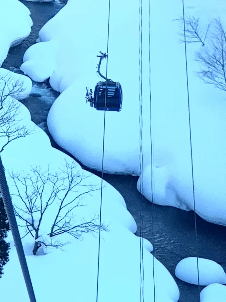 The Dragondola gondola crossing a snowy valley between Naeba and Kagura